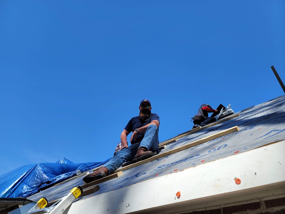 Ed on a customer's roof helping the crew